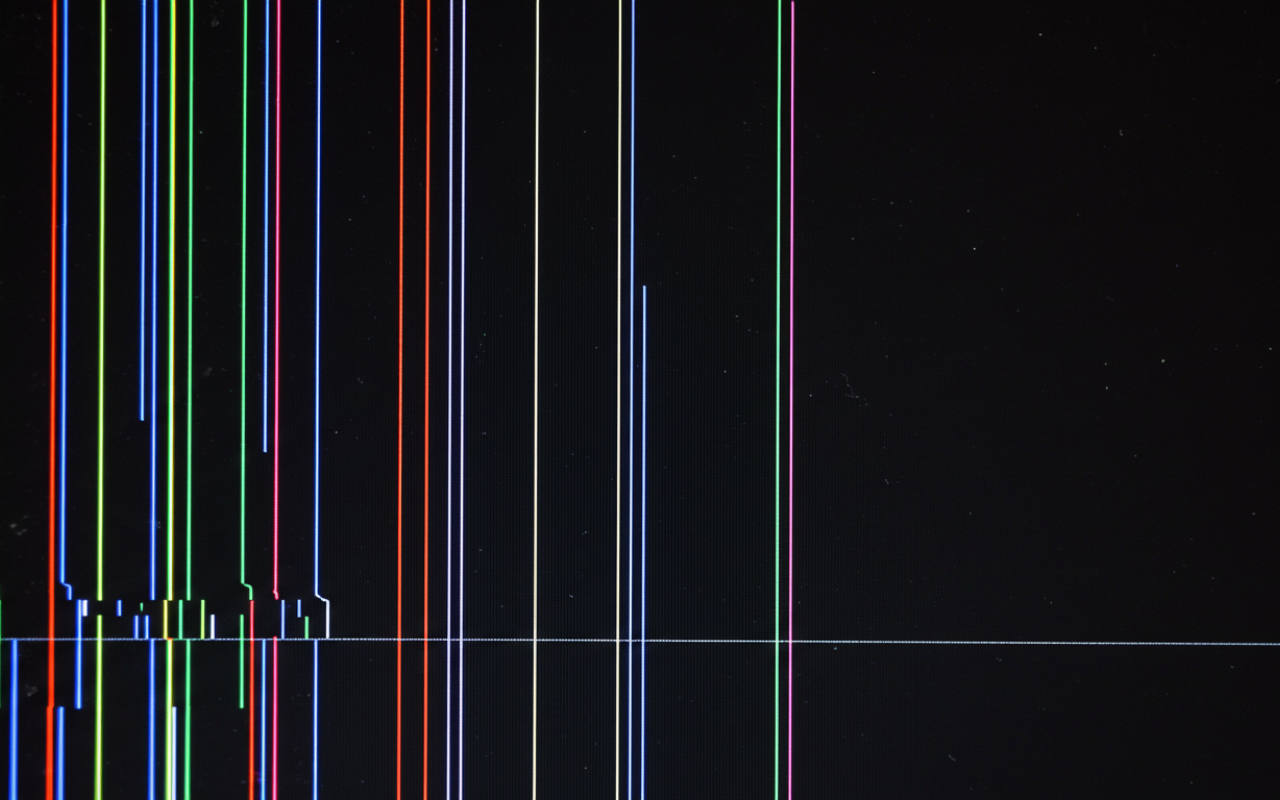 Laptop with screen lines being connected to an external monitor for diagnosis
